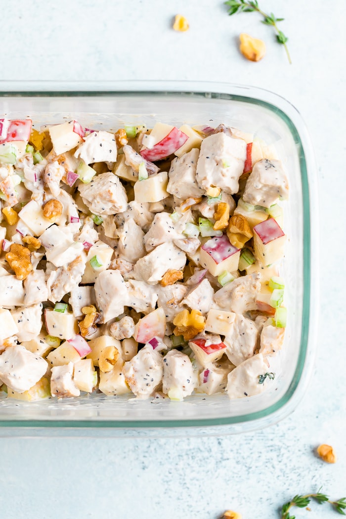 Rectangle glass container filled with grilled chicken waldorf salad.