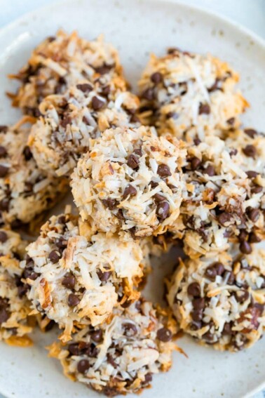 Plate of almond coconut cookies make with chopped almond, coconut flakes and chocolate chips.