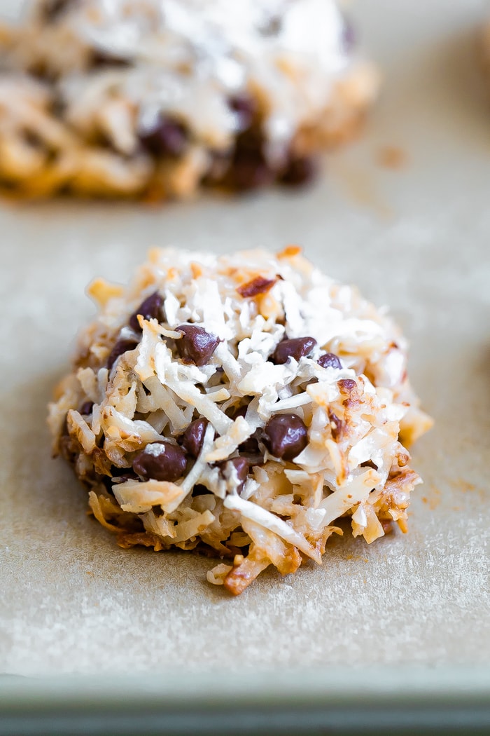 Almond coconut chocolate chip cookie on parchment paper.