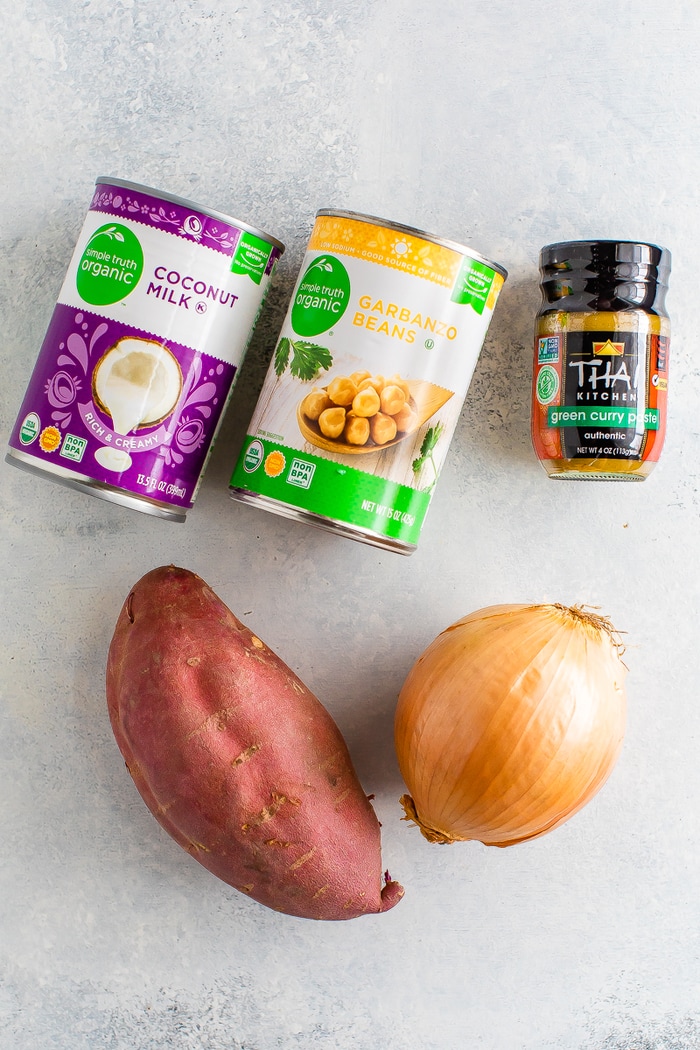 Ingredients used to make sweet potato curry: can of coconut milk, can of chickpeas, green curry paste, sweet potato and onion.