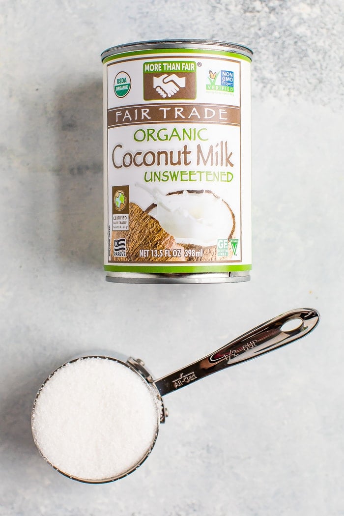 Can of coconut milk and a measuring cup of sugar.