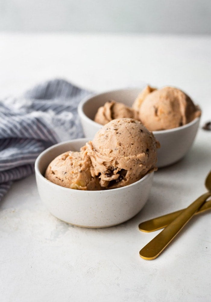 Two bowls with scoops of chocolate banana ice cream.