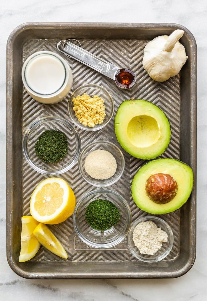 Baking tray with ingredients for avocado ranch dressing laid out.