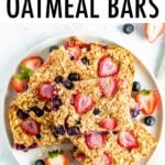 Oatmeal bars made with strawberries and blueberries stacked on a plate.