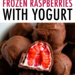 Bowl of chocolate covered frozen raspberries with yogurt. One raspberry is cut in half.