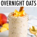 Jar filled with peach overnight oats and topped with peaches and cinnamon.