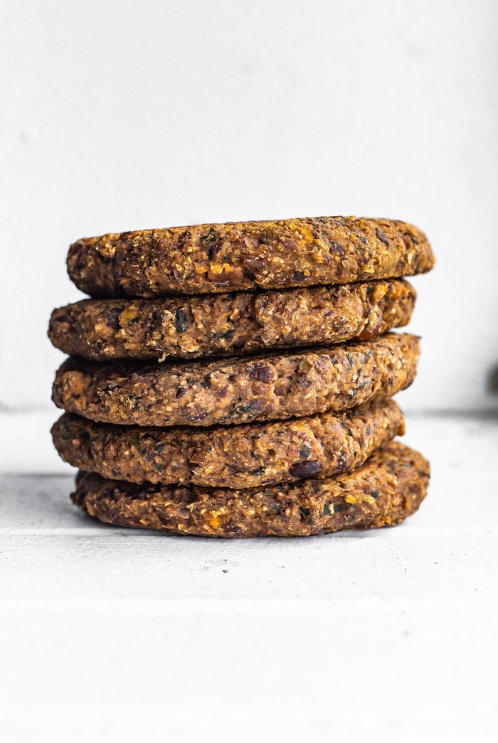 Five sweet potato black bean burgers stacked.