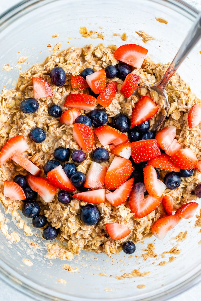 Glass mixing bowl with the batter for berry oatmeal bars.