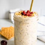 Straight on shot of cherry cheesecake overnight oats in a mason jar.