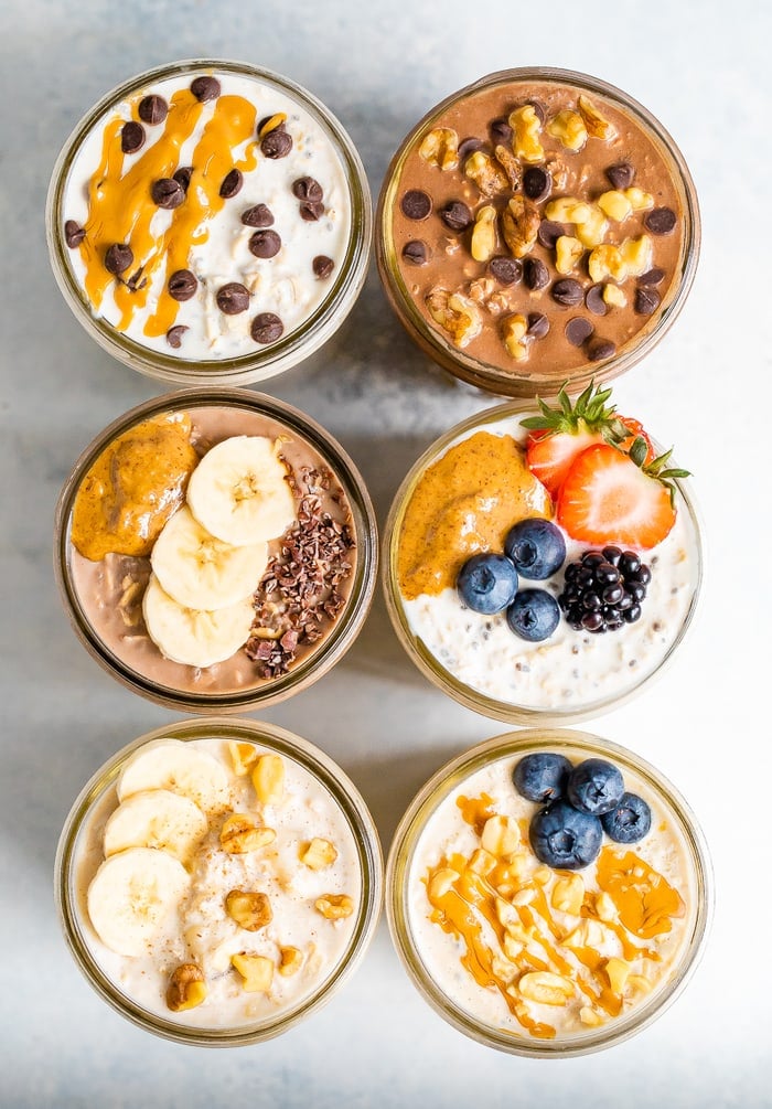 Overhead shot with 6 jars of overnight oats, each with different toppings.