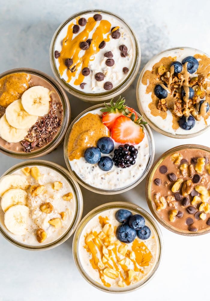 Overhead shot with 7 jars of overnight oats, each with different toppings.