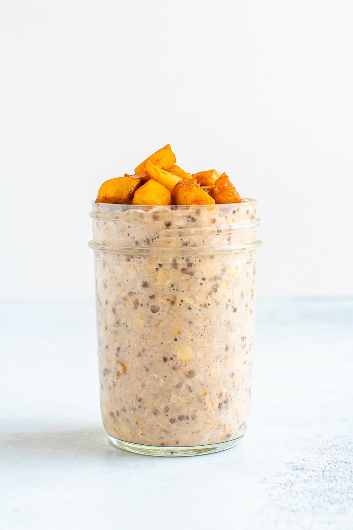Peach overnight oats in a mason jar.