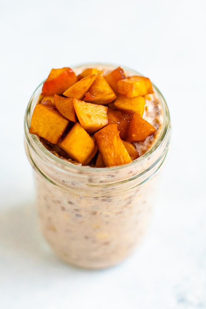 Peach overnight oats in a mason jar.