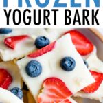 Squares of frozen yogurt berry bark on a plate.