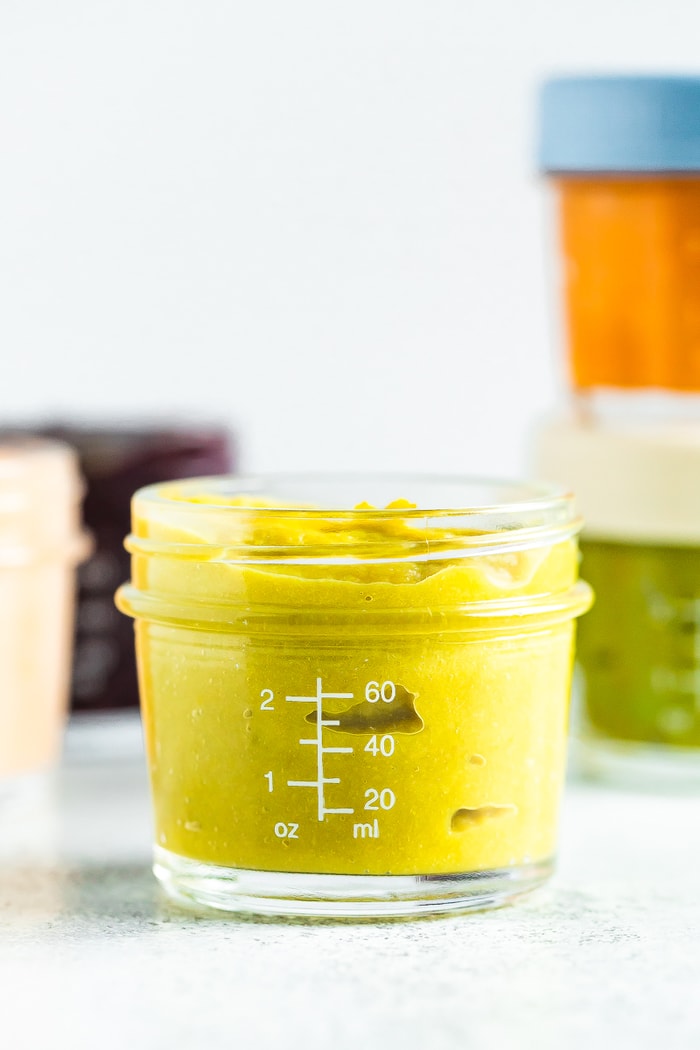 Asparagus apple baby food in a 4 oz baby food jar.