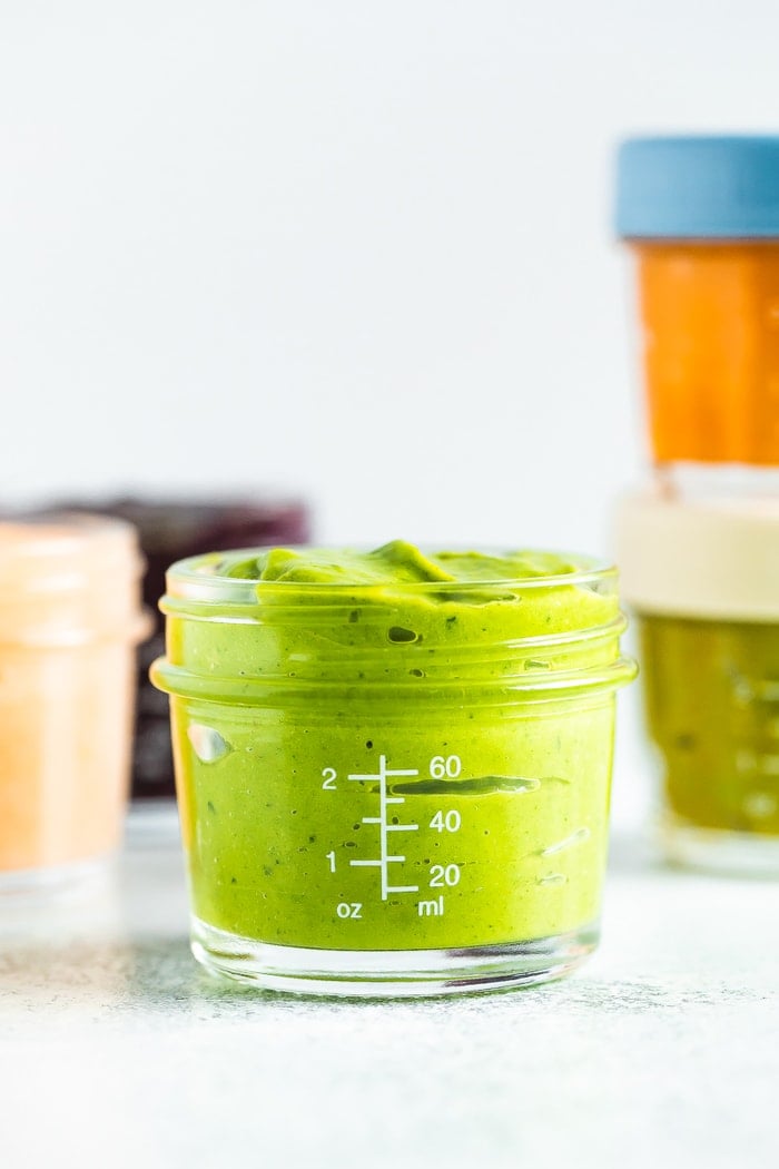 Avocado peach pineapple kale baby food in a 4 oz baby food jar.