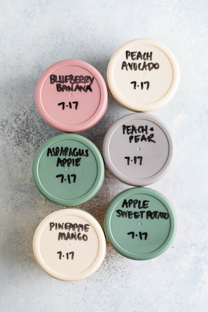 6 baby food jars with hand written labels.