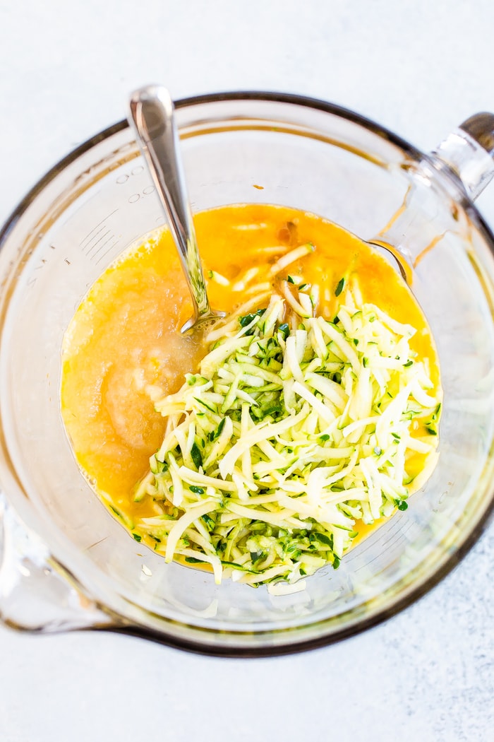 Mixing Bowl with eggs, applesauce, vanilla and shredded zucchini.