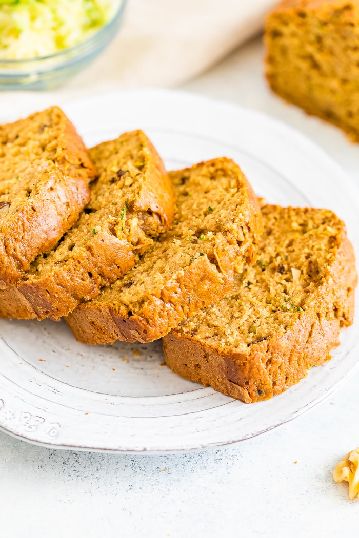 Plate with 4 thick slices of zucchini bread.