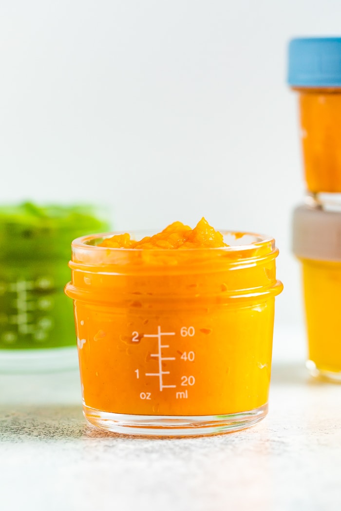 Sweet potato apple baby food in a 4 oz baby food jar.