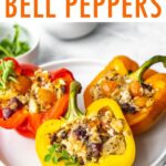 Three tuna stuffed bell peppers on a dinner plate.