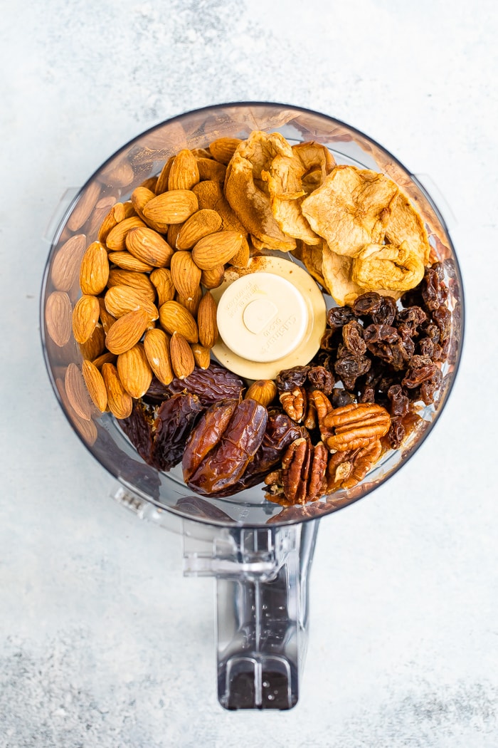 Nuts and dried fruit in a food processor to make apple pie energy balls.