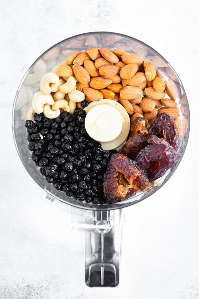 Food processor with dried blueberries, dates, almonds and cashews.