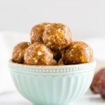 Cashew date balls in a light blue bowl.