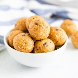 White bowl full of cookie dough protein balls.