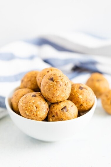White bowl full of chocolate chip cookie dough protein balls.