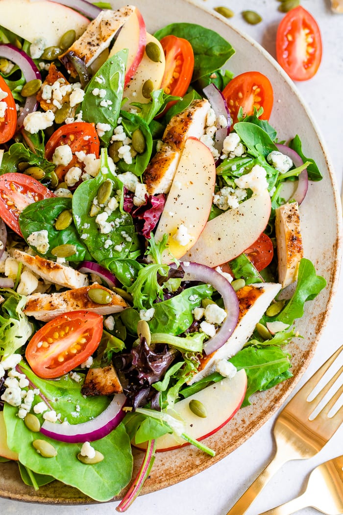 Fuji apple chicken salad with gorgonzola cheese, pepitas, tomatoes and dressing.