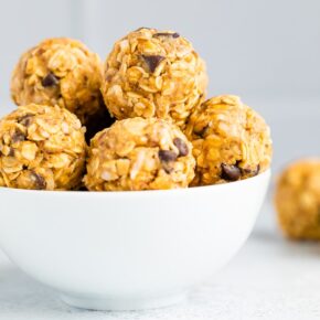 White bowl full of peanut butter chocolate chip energy balls.