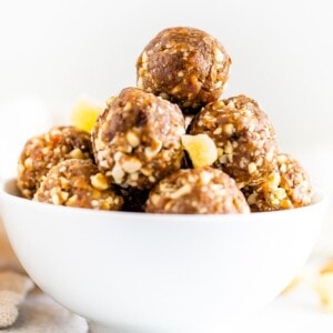 Straight on shot of a white bowl with gingerbread energy balls.