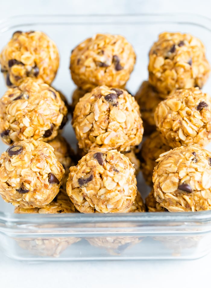 Square food storage container packed with peanut butter energy balls.