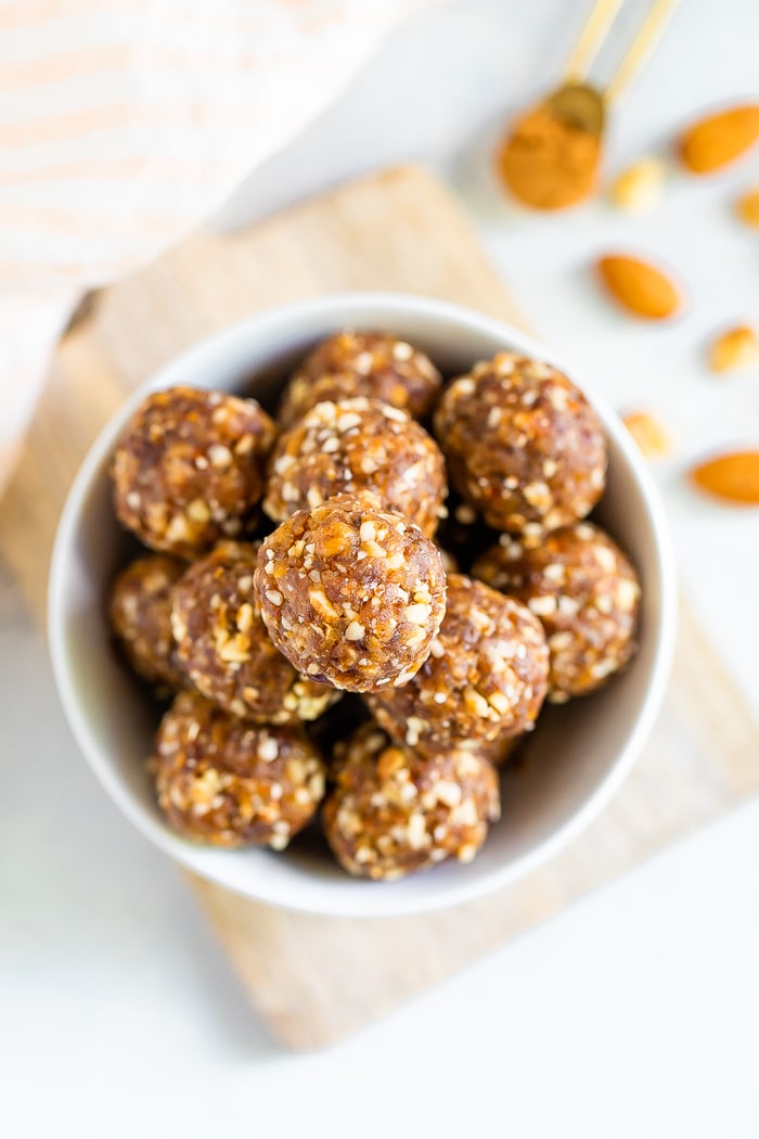 Overhead shot of pumpkin pie energy balls in a white bowl.