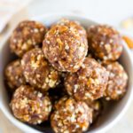 Close up shot of pumpkin pie energy balls in a white bowl.