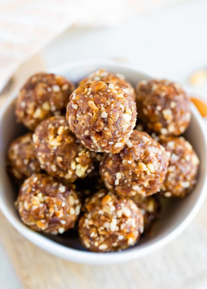 Close up shot of pumpkin pie energy balls in a white bowl.