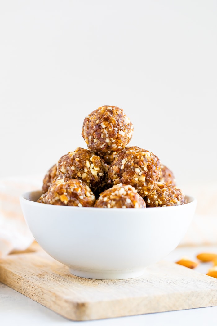 Straight on shot of pumpkin pie energy balls in a white bowl.