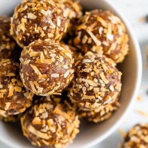 Overhead shot of samoa energy balls in a white bowl.