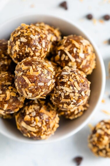 Overhead shot of samoa energy balls in a white bowl.