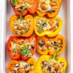 Baking dish with 8 tuna stuffed bell peppers.