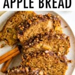 Plate with 5 slices of apple bread with a cinnamon pecan crust. Two cinnamon sticks are on the plate.