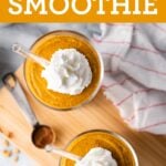 Two glasses of pumpkin pie smoothies topped with whipped cream.