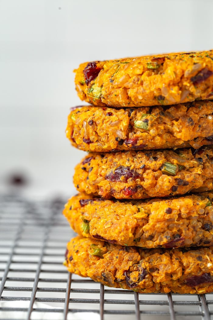 Five sweet potato quinoa cakes stacked close up.