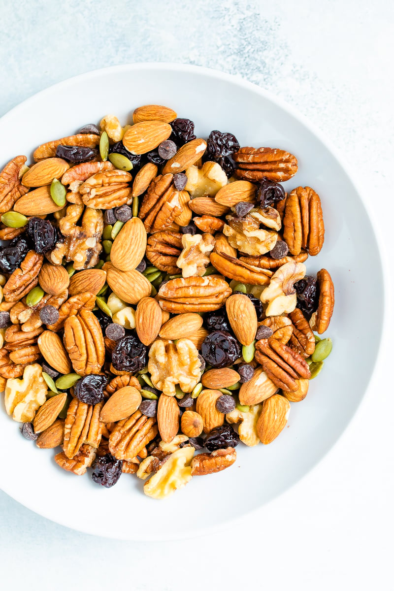 Bowl of trail mix with nuts, seeds and fruit.