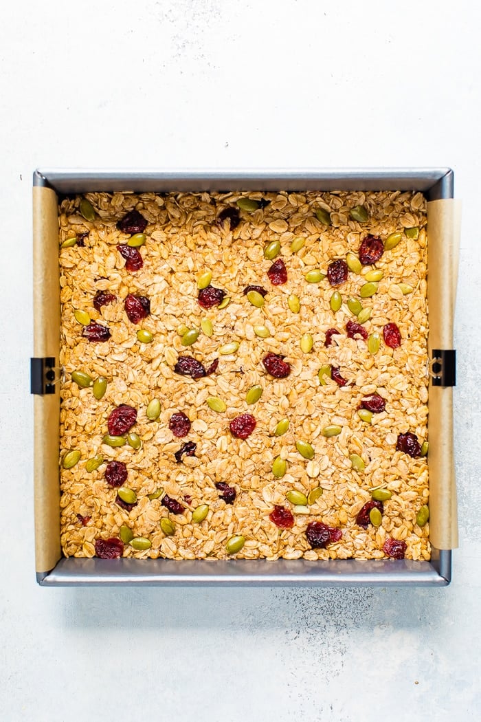 Pumpkin spice granola bar mixture in a pan before being cut.