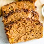 Three slices of apple bread. The top has a crust of cinnamon and pecans.