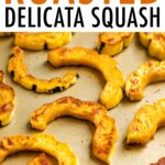 Half moon shapes of roasted delicata squash on a sheet pan.