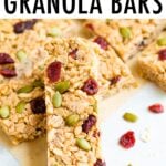 Pumpkin spice granola bars propped up on each other and made with cranberries and pepitas.