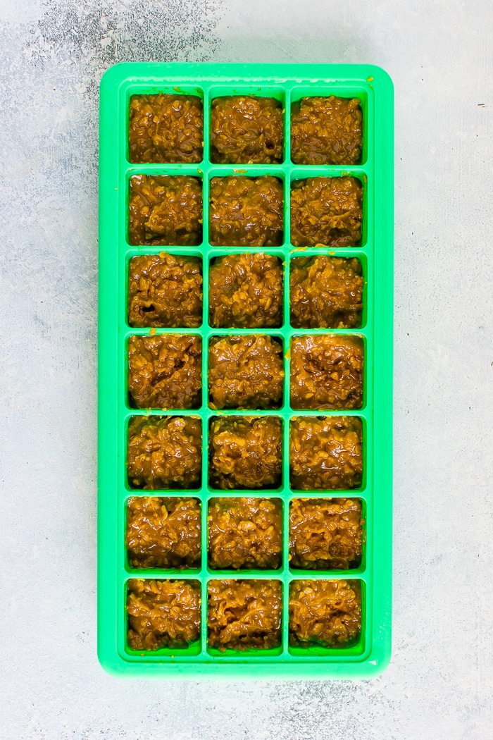 Butterfinger bites in a green silicone ice cube tray.